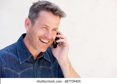 Close Up Side Portrait Of Older Man Laughing And Talking On Mobile Phone