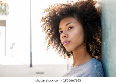 Close Up Side Portrait Serious African American Girl Leaning Against Wall Outside