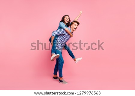 Close up side profile full length body size photo of piggy back hug she her he him his lady guy hurry to help superhero fly concept wearing casual jeans denim plaid shirts isolated on rose background
