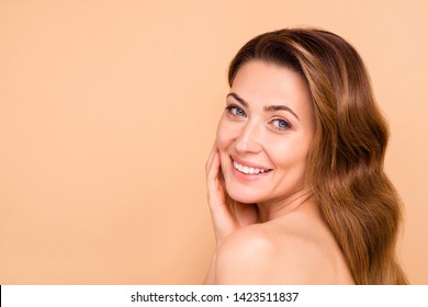 Close up side profile photo beautiful amazing mature she her lady white teeth salon spa procedures aesthetic pretty ideal appearance nude arm hand palm touch cheek isolated pastel beige background
