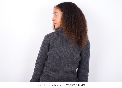 Close Up Side Profile Photo Beautiful Teen Girl With Afro Hairstyle Wearing Grey Turtleneck Sweater Against White Not Smiling Attentive Listen Concentrated