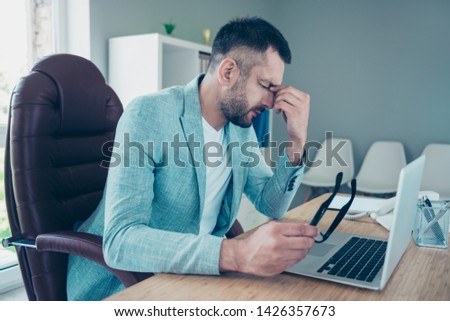 Close up side profile photo handsome he him his macho guy had no rest relax sleep all week take eyewear off hold nose bridge overwhelmed day night working notebook table sit office chair wear jacket