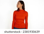 Close up side profile photo Young beautiful woman wearing red sweater not smiling attentive listen concentrated