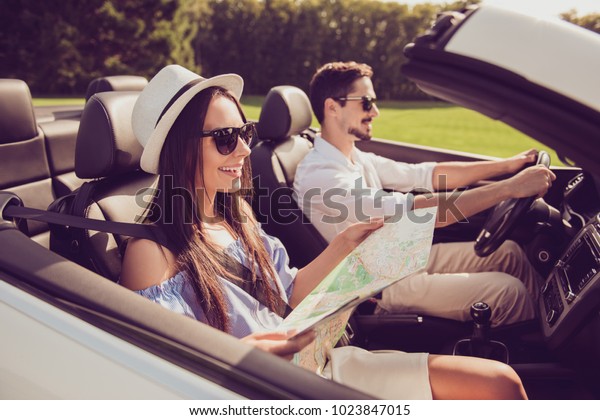 Close up side profile shot of family journey,\
escape ride, vehicle rent. Married driver, lady holds sheet scheme,\
plan the way to go. Drive, freedom, navigation, outdoors,\
illustration cartography