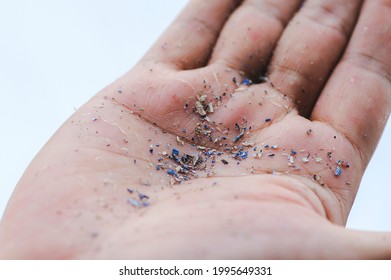 Close up side shot of microplastics lay on people's hands. Concept of water pollution and global warming. Climate change idea.