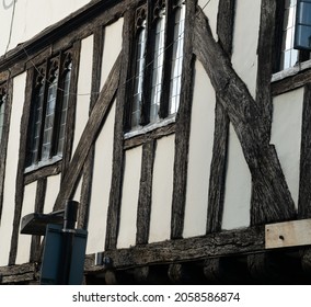 Close up side of Tudor timber framed cottage house with tall windows at Saffron Walden, England