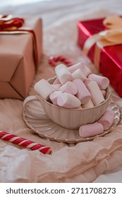Close Up Side View of Mug with Marshmallows and Gift Boxes in Background