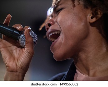 Close Up Side View Of One Young African Singer Singing On The Stage