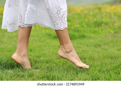 Close up side view portrait of a woman bare feet walking on the grass in the mountain