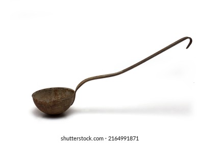 Close up side view profile of old rusted retro vintage soup ladle spoon kitchen helper on white background