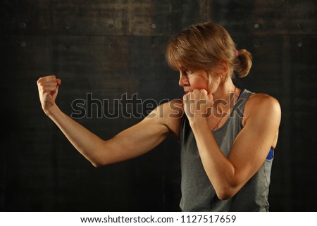 Image, Stock Photo Close up side view profile portrait of one young middle age athletic woman shadow boxing in sportswear in gym over dark background, looking away