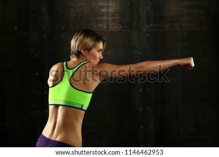 Similar – Image, Stock Photo Close up side view profile portrait of one young athletic woman shadow boxing in sportswear in gym over dark background, looking away
