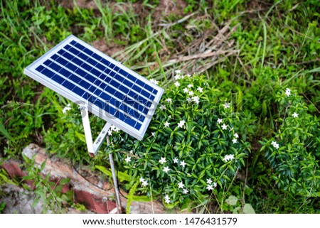 Close up side view solar cell or photovoltaic panel  for use in the garden. on a background of garden
