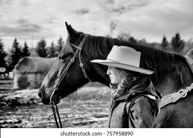 close up side view of a young woman and horse in black and white photography