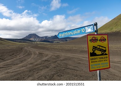 Close up of sign directing towards Hrafntinnusker on the plateau with dirt road nearby Katla volcano in Iceland; warning sign in Icelandic warning of Extreme Rough road only for large vehicles