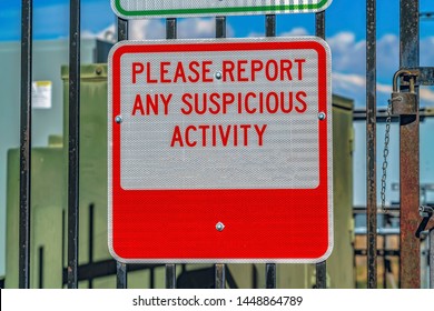 Close Up Of A Sign That Reads Please Report Any Suspicious Activity