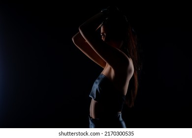 Close Up Silhouette Of Attractive Girl Posaing In Studio While Being Dressed In All Black Clothes