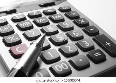 Close Up Silver Calculator With Pen On White Paper