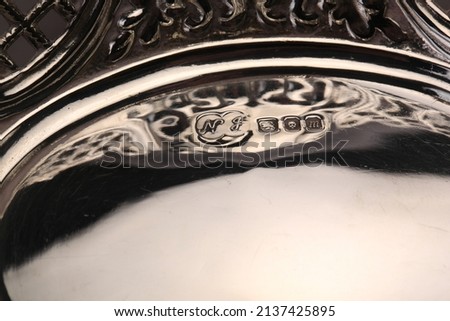 A close up of silver hallmarks