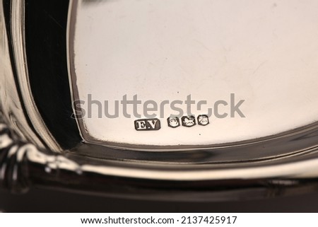 A close up of silver hallmarks