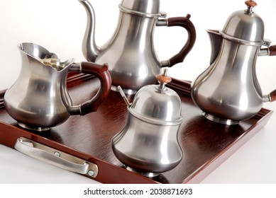 Close Up Of Silver Tea And Coffe Pots Set On A Dark Wood Tray, Isolated