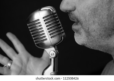 Close Up Of A Singers Mouth Singing Into A Vintage Microphone With A Black Background