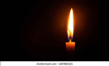 Close Up Single Candle Light And Flame On Black Background