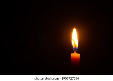 Close Up Single Candle Light And Flame On Black Background