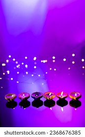 Close up of six diwali candles with copy space on purple background. Diwali, festival of lights, religion, hindu tradition and celebration. - Shutterstock ID 2368676385