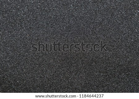 Close up of of skateboard grip tape. Macro photograph of sandpaper texture