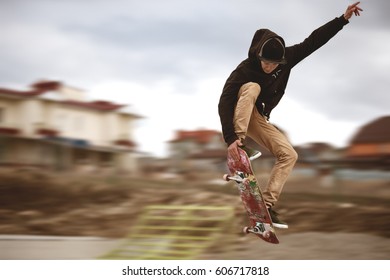 Close up of a skateboarders feet while skating active performance of stunt teenager shot in the air on a skateboard in a skate park - Powered by Shutterstock