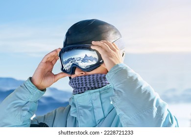 Close Up Of The Ski Goggles Of A Man With The Reflection Of Snowed Mountains. Man In The Background Blue Sky.  Winter Sports. - Shutterstock ID 2228721233
