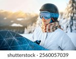 Close up of the ski goggles of a woman with the reflection of snowed mountains. Ski Woman on the sunset background. Winter Sports.