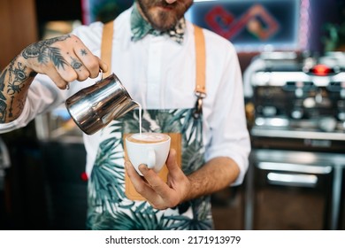 Close Up Of Skilled Barista Using Milk While Making Frothy Drink In A Pub.