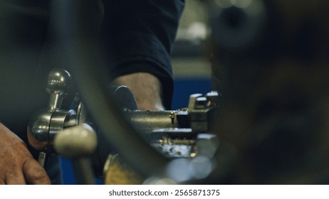 Close up of skilled metalworker operating a lathe machine, shaping metal in a factory workshop, demonstrating industrial manufacturing processes and precision engineering