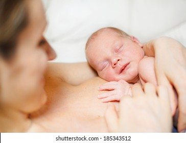 Close Up Of Sleeping Newborn Baby Aged 11 Days On Mother's Chest