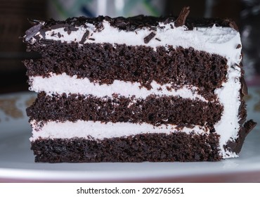 Close Up Of A Slice Of Black Forest Cake On A White Plate.