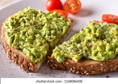 Close Up Of A Slice Of Delicious Avocado Toast With Sliced Tomato.