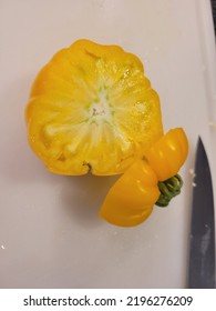 Close Up Of Sliced Heirloom Organic Yellow Tomato From Garden