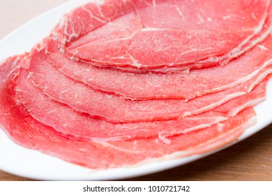 Close Up Of Sliced Raw Beef Sirloin Tip On White Dish