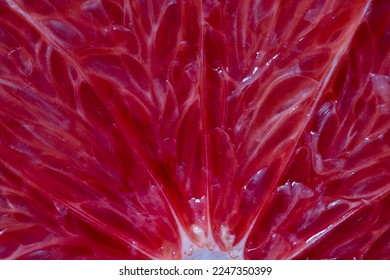 Close up of sliced ripe grapefruit, macro. Red fresh grapefruit surface background or texture. Top view - Shutterstock ID 2247350399