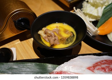 Close Up Sliced Wagyu Beef In Sukiyaki Shabu Shabu, Japanese Hot Pot Dipped In Organic Raw Egg Yolk Sauce