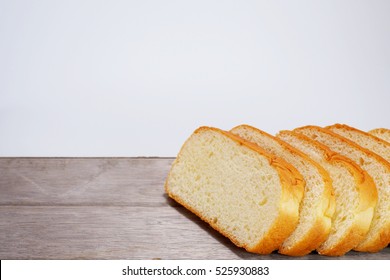 Close up of sliced wholemeal bread on a wooden table.