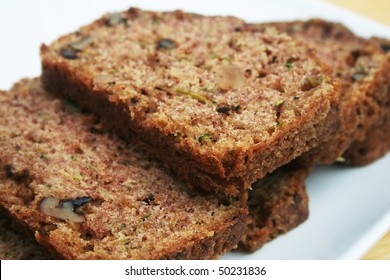 Close up of slices of zucchini bread on a white plate