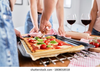 Close up of slicing delicious homemade pizza on the table                                - Powered by Shutterstock