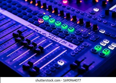 Close up of sliders and button on Audio Mixing Desk at live event - Powered by Shutterstock