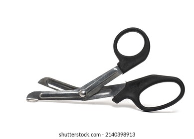 Close up of slightly opened blunt metal bandage scissors with black handles for safe cutting of wound dressings when treating injuries on white background