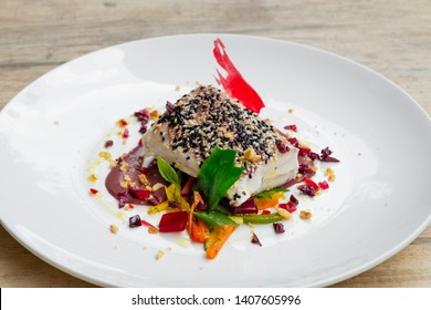 Close Up Of A Slow Cooked , Sous Vide , Tuna Loin With Black And White Sesame Crust, Olive Sauce, Mixed Vegetable And Wine Gelatine , White Plate , Natural Light Food Photography, Chef Table Inspired 