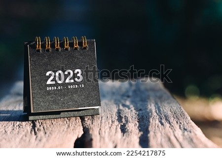 close up small black 2023 calendar on table, planning and manage time for success business, happu new year and holiday season concept