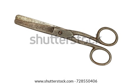 Close up of small old vintage metal closed scissors isolated on white background